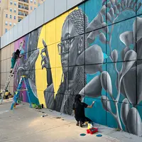 two artists working on a colorcon mural from 2022